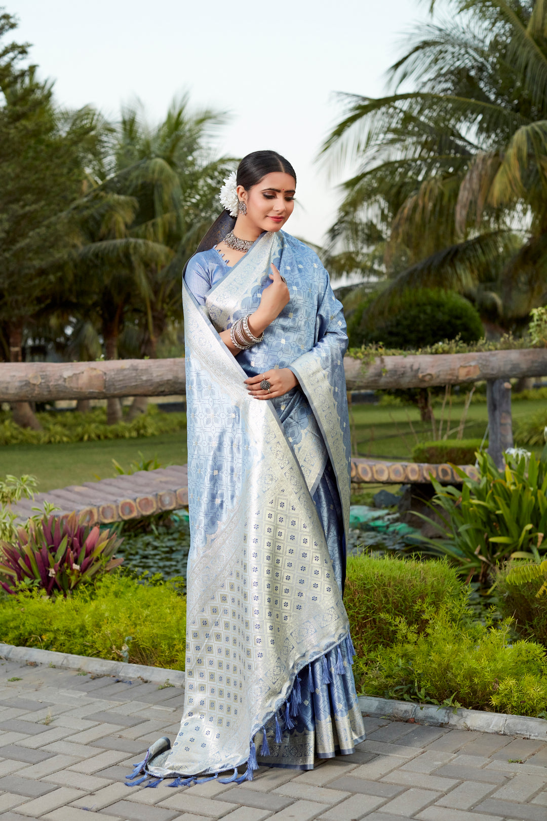 Stunning blue Kanjivaram silk saree with designer border and intricate butta work, perfect for festive occasions.