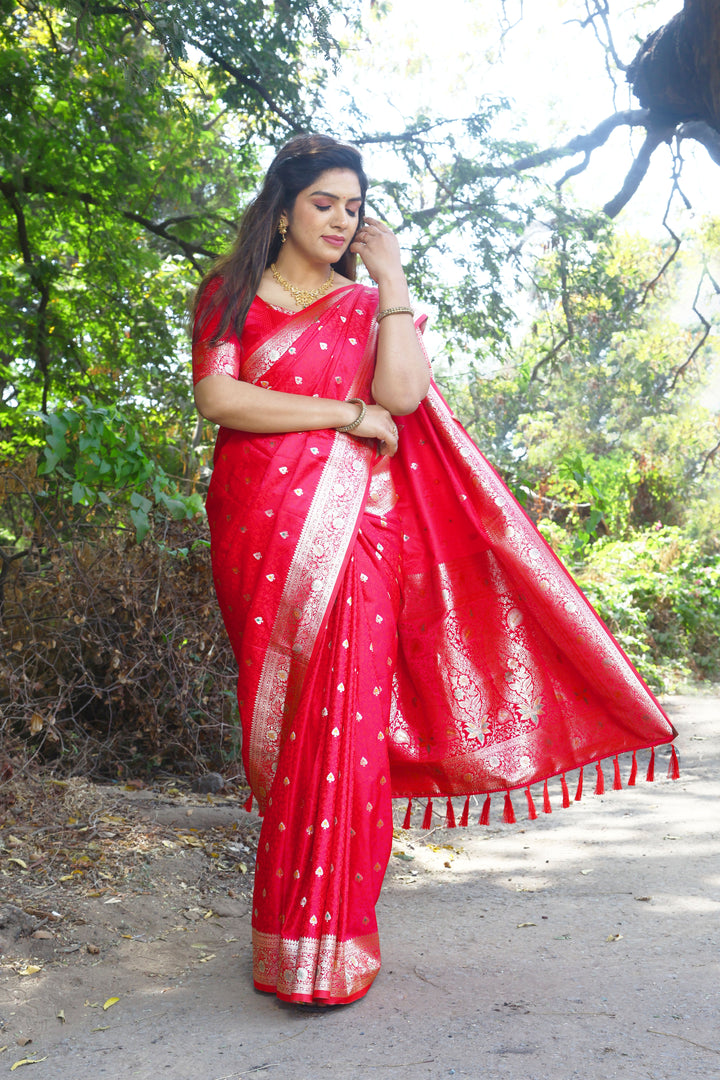 Elegant red Kanjivaram silk saree with detailed weaving and a luxurious shine, perfect for grand events.