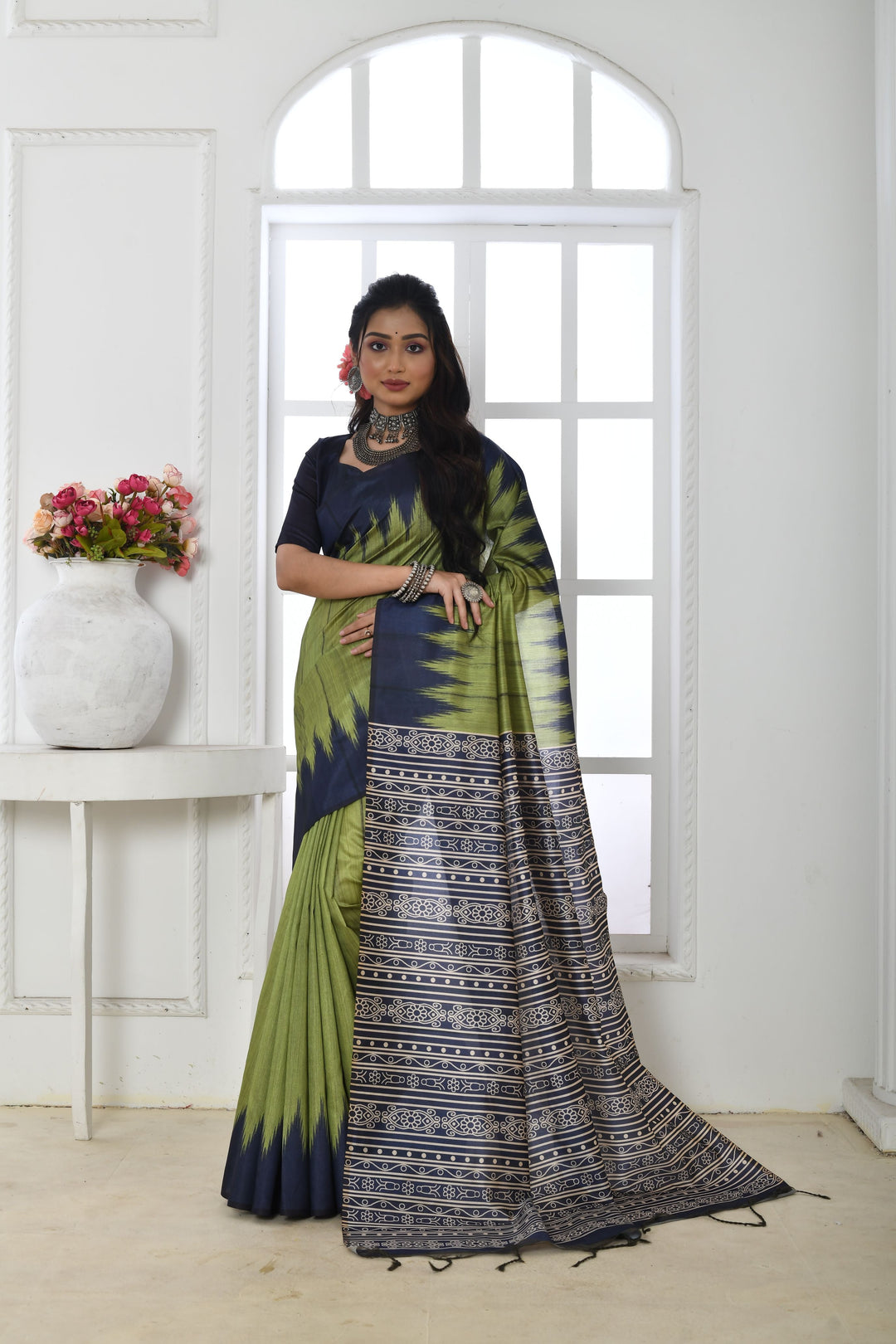 Experience grace with this soft Tussar silk saree, featuring a printed temple border and traditional fabric pattern.