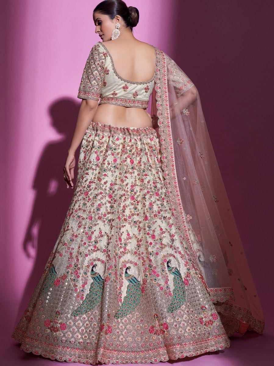 Soft cream net lehenga with sequins, dori, and stone details.