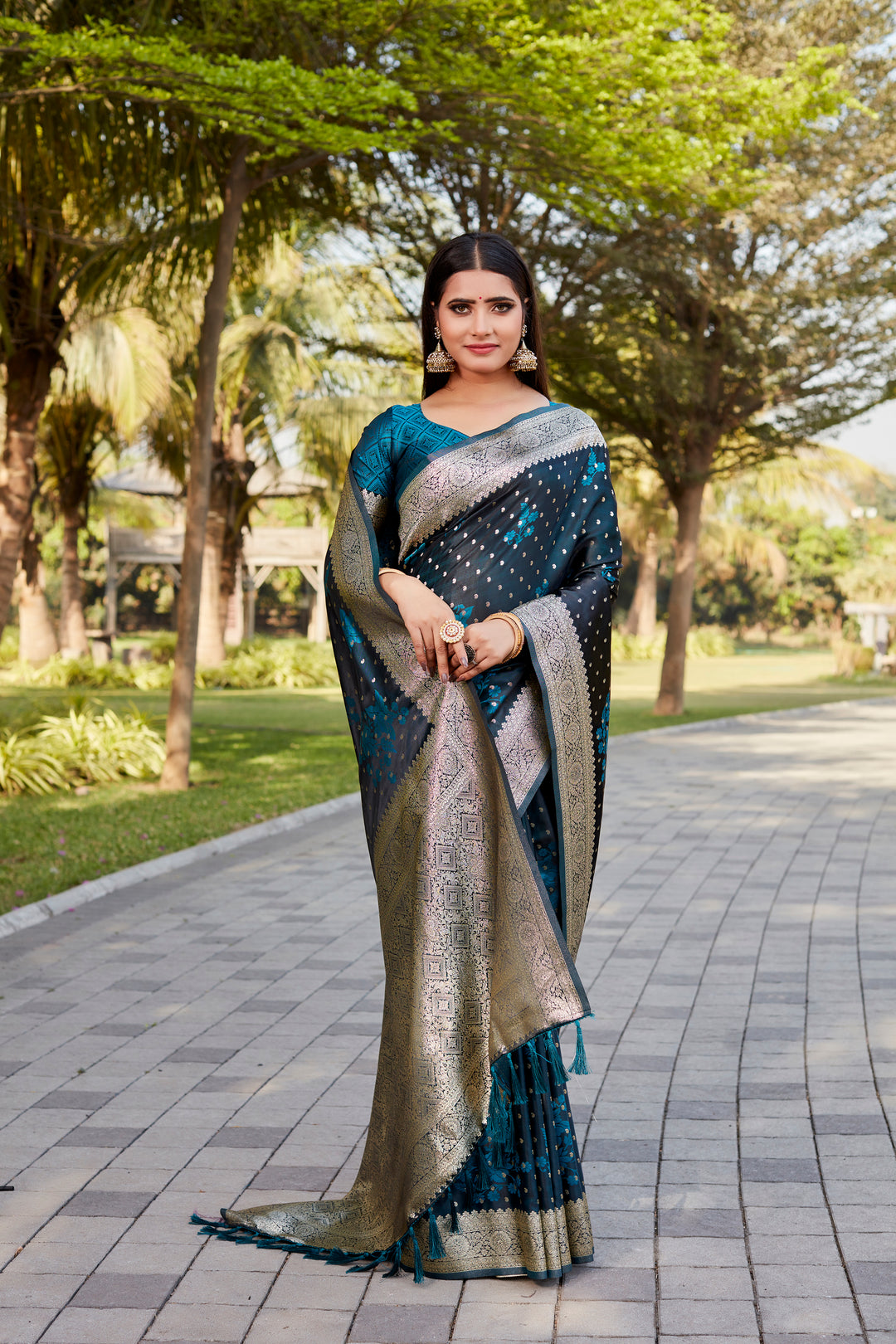 Teal-blue Soft Satin Kanjivaram saree with intricate butta design and shimmering finish.