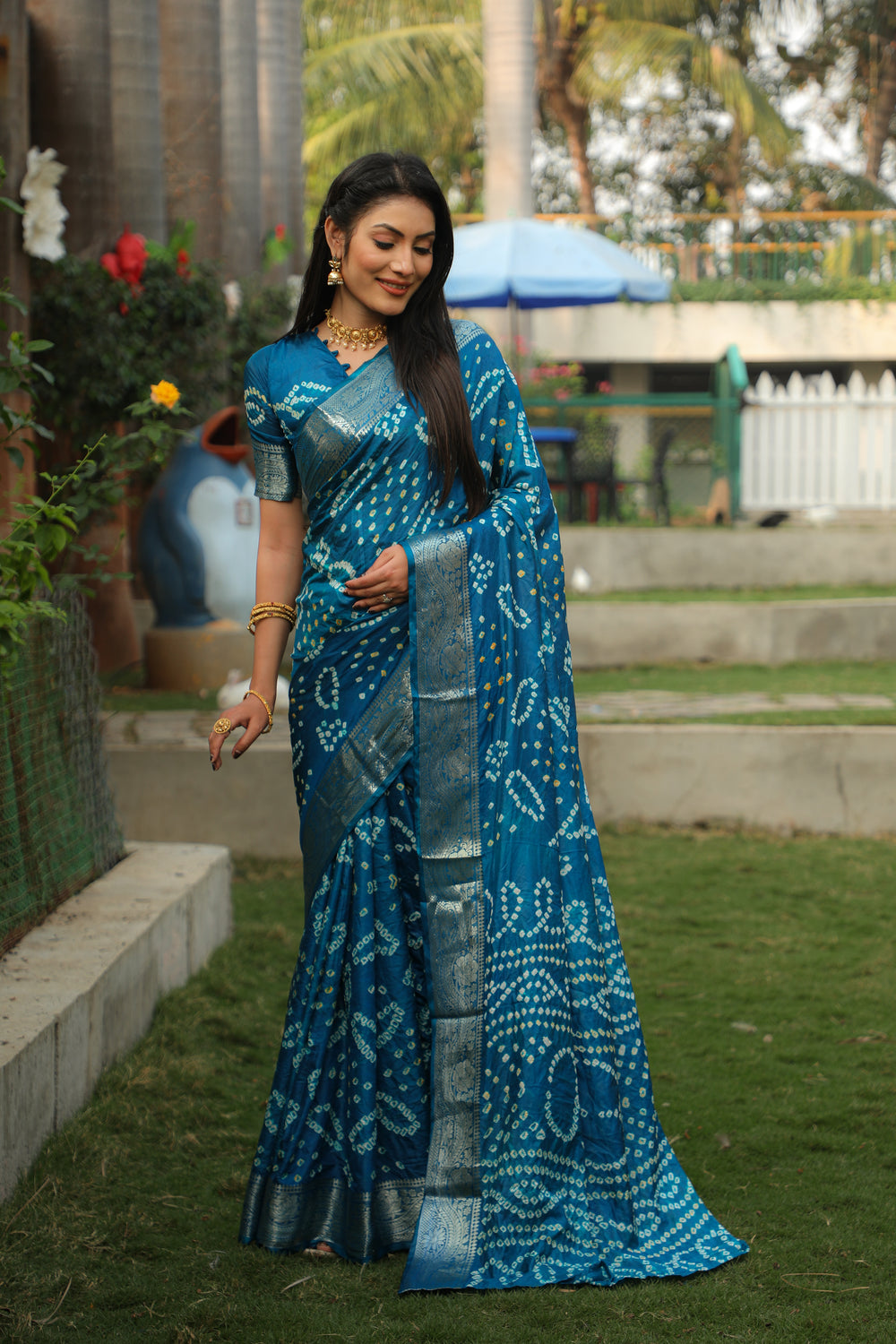 Traditional teal blue Bandhej saree with rich jari border and Bandhej pallu, a timeless piece for weddings and celebrations.