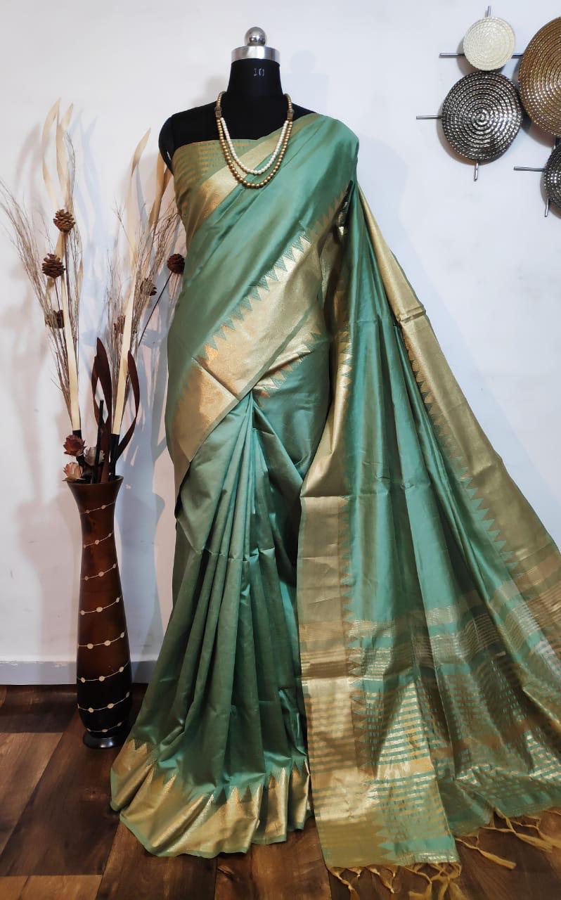 Latest green saree with traditional zari border and pallu, a beautiful addition to any Indian sadi collection.