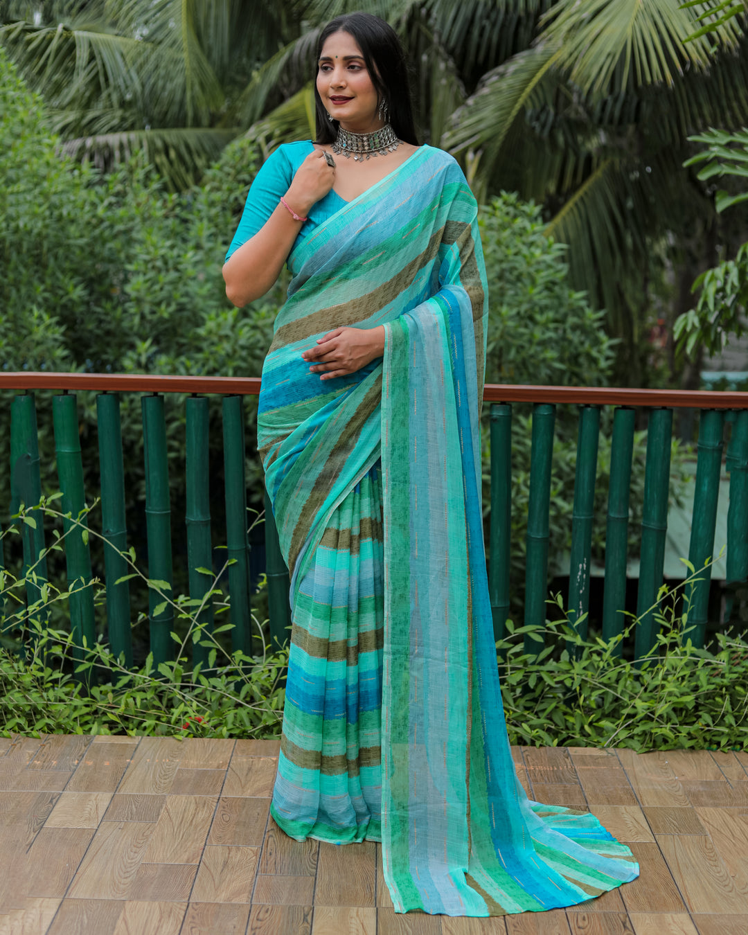 A stunning sky blue Moss chiffon saree, enhanced with a gorgeous gold foil pattern, perfect for weddings and special celebrations.