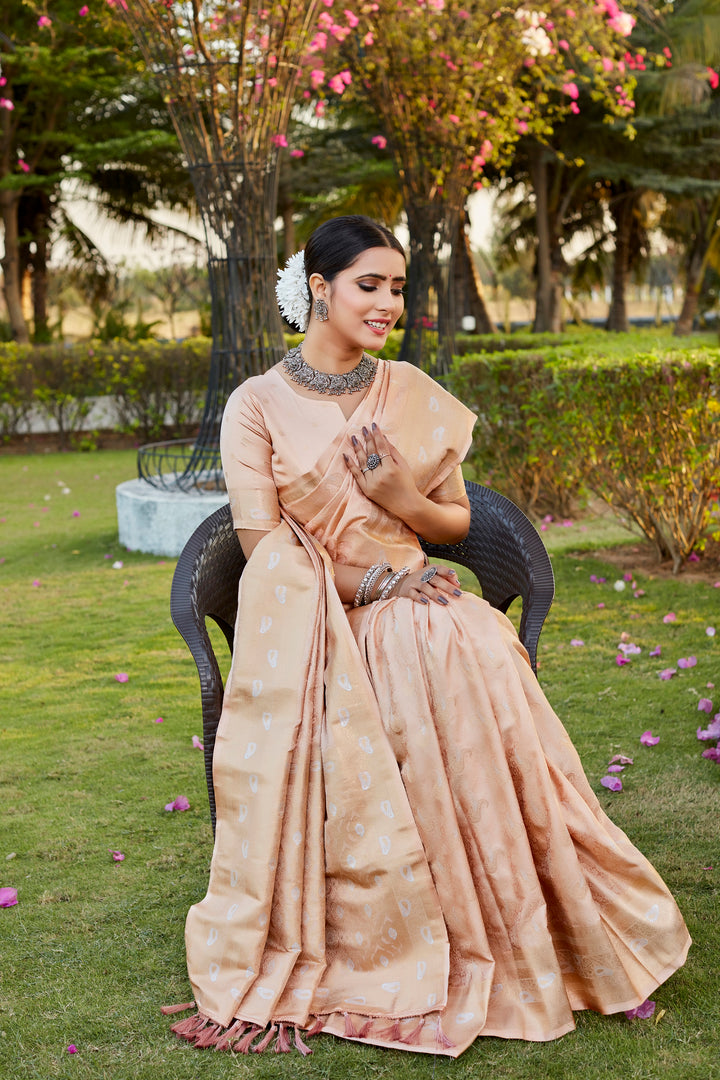 Graceful beige Kanjivaram saree with intricate butta work and an exquisite woven pallu, perfect for traditional events.