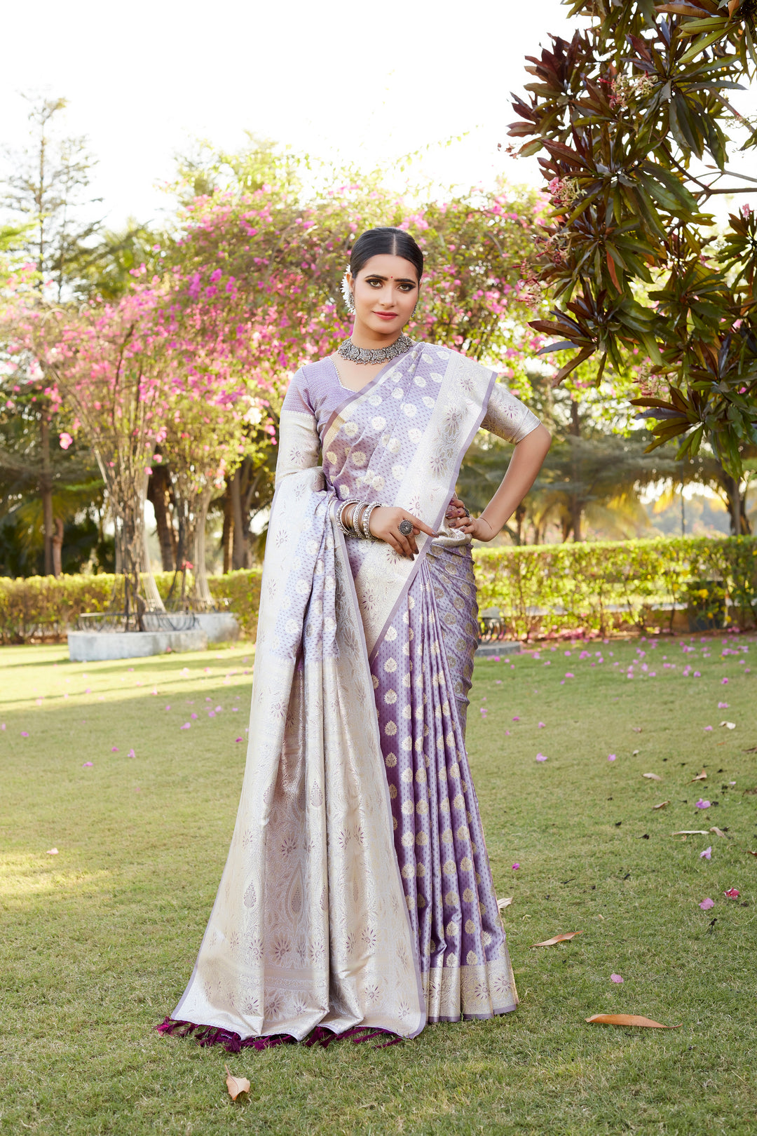 Kanjivaram Soft Satin Silk saree in purple, showcasing intricate butta weaving and a designer satin border for a luxe look.