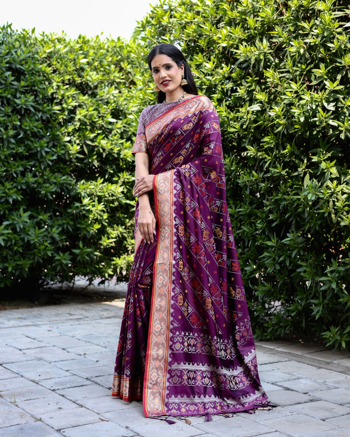 Elegant purple Bandhej silk saree with zari woven pallu and matching blouse, perfect for festive occasions.