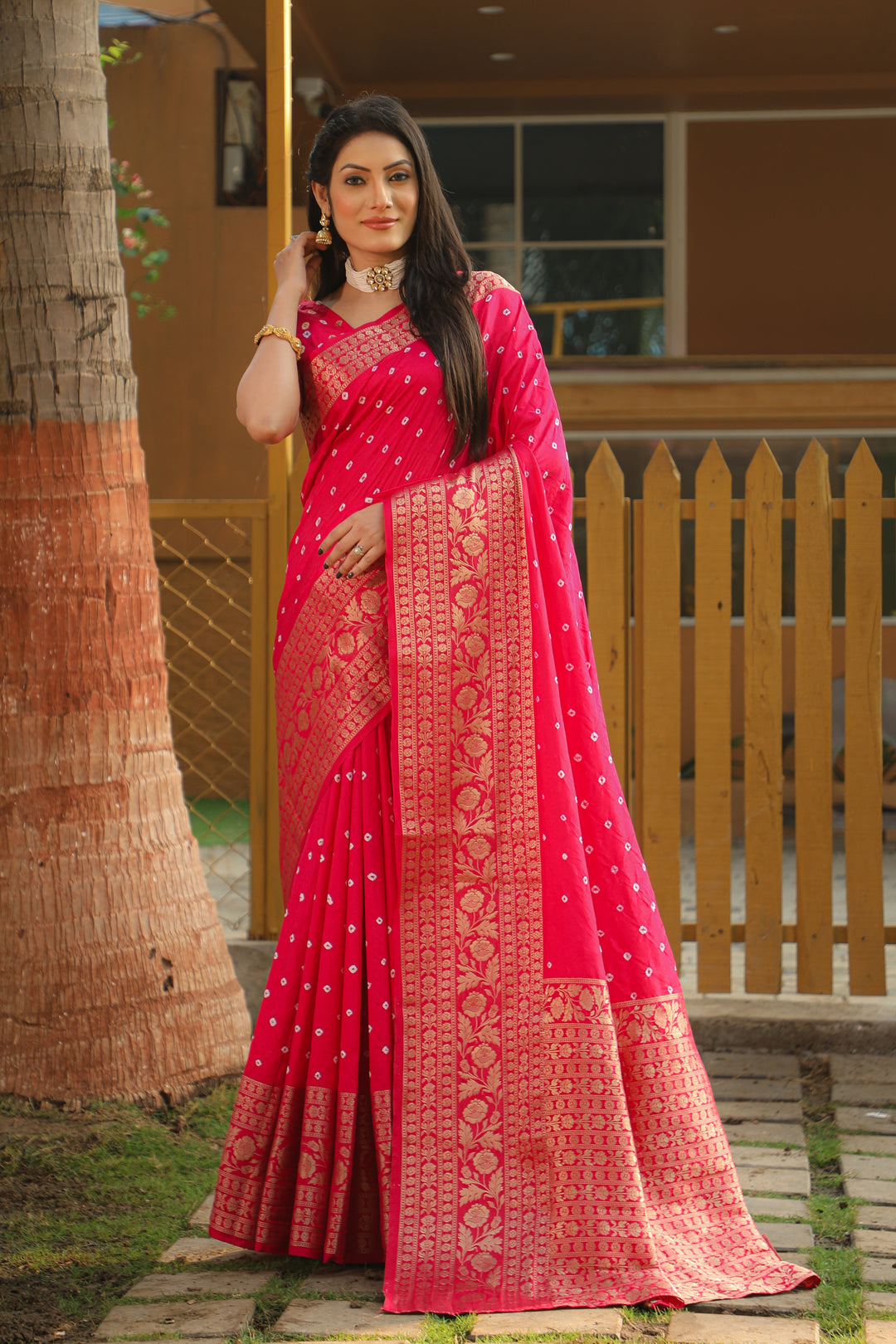 Stunning pink Bandhej Kanjivaram silk saree with intricate zari weaving and a rich pallu, perfect for weddings and festive celebrations.