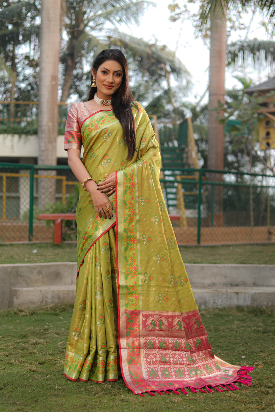 Elegant olive organza saree with lightweight Ikkat Patola design, perfect for festive celebrations.