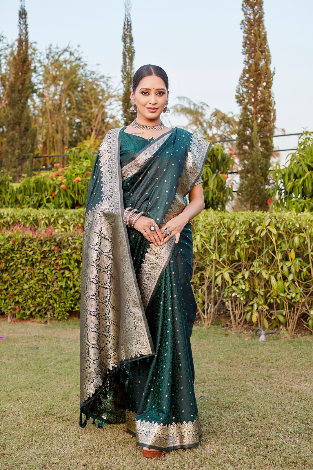 Elegant Dark-Green Kanjivaram Silk Saree with intricate Butta design and beautiful designer border for weddings.