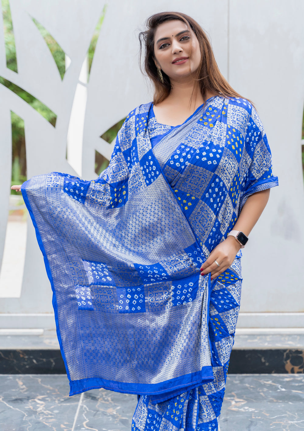 Stunning blue Bandhej silk saree featuring an elegant zari border, designed for grand celebrations and festive events.