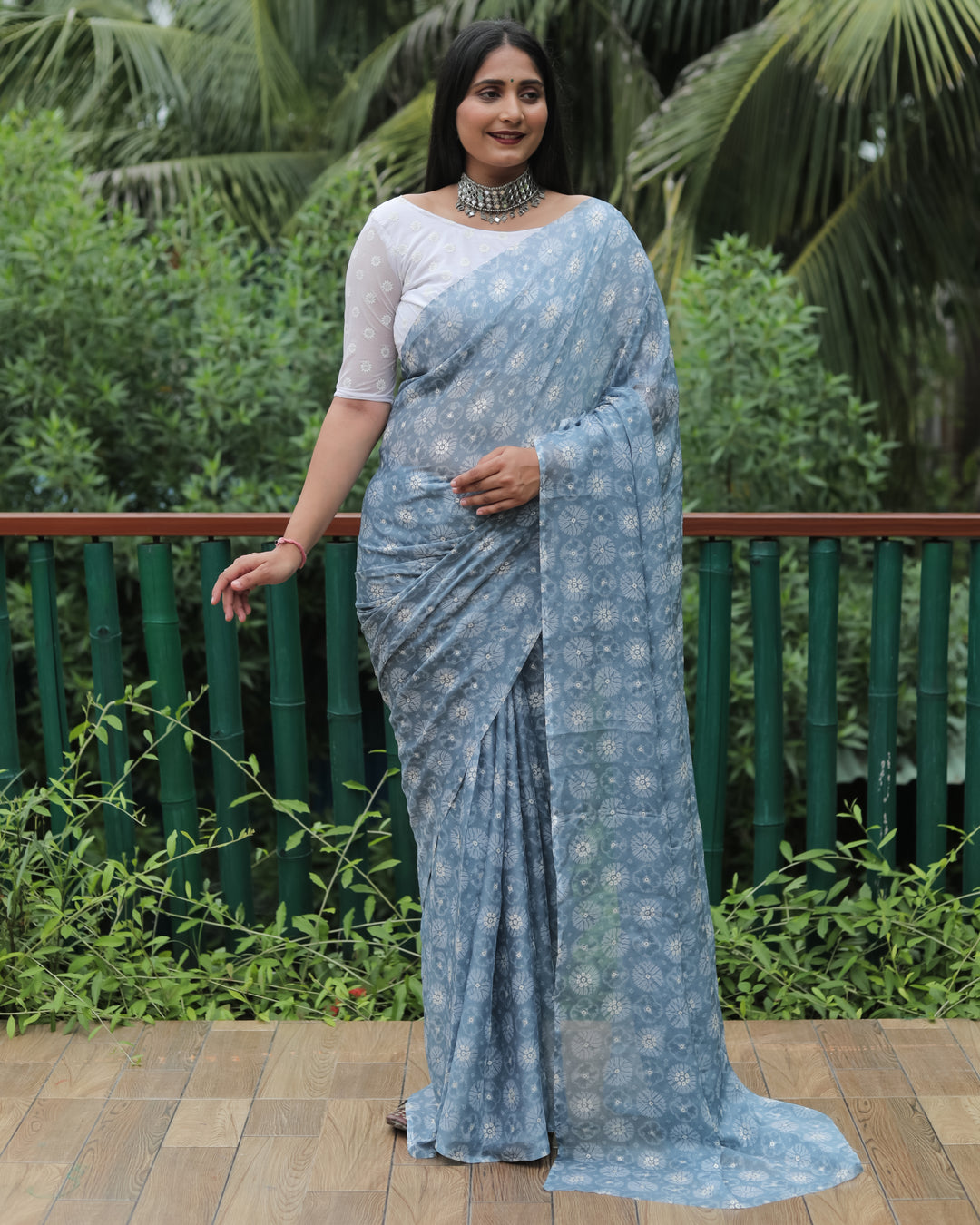 Graceful grey chiffon saree, designed with luxurious foil detailing for a timeless bridal look.