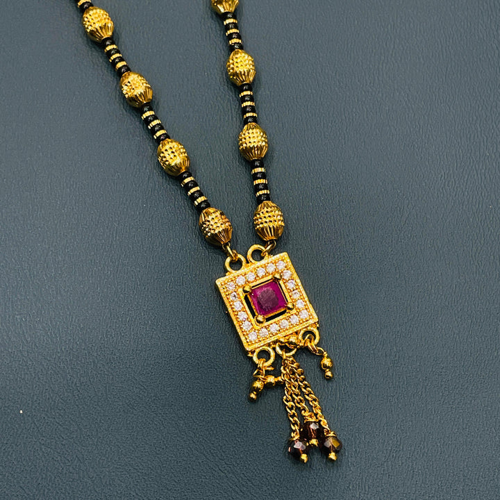 Gold and black mangalsutra in gold-plated alloy, stylish traditional necklace for women.