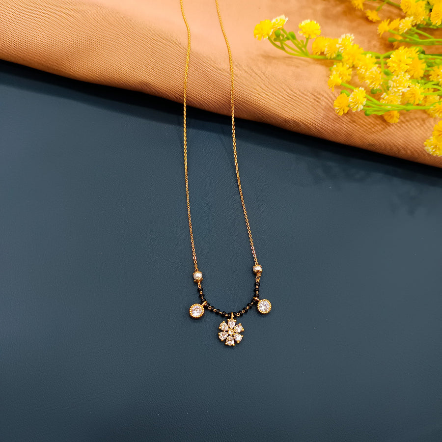 Gold-plated black beaded mangalsutra, crafted in alloy, ideal for classic elegance.