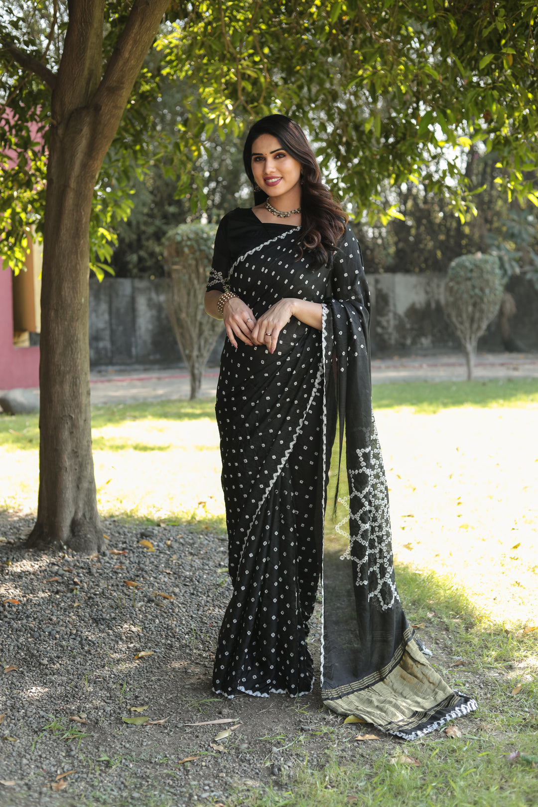 Traditional Black Bandhej Silk Saree with exquisite Zari weaving and original design for grand events.