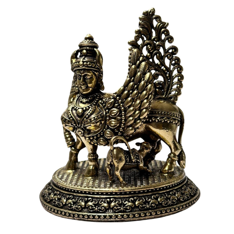 Handcrafted golden brass cow idol, representing abundance and good fortune.