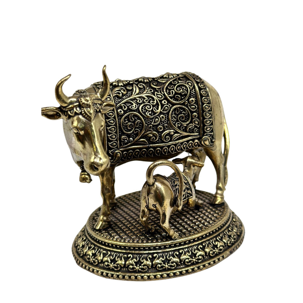 Handcrafted brass cow with calf figurine, representing maternal love and nurture.