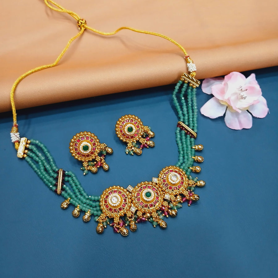 Classic gold-tone choker set with antique Indian detailing, perfect for formal celebrations.