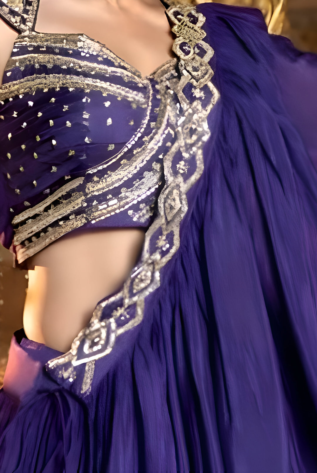 Fashion-forward dark purple lehenga with crop top, great for stylish women looking to stand out at parties.