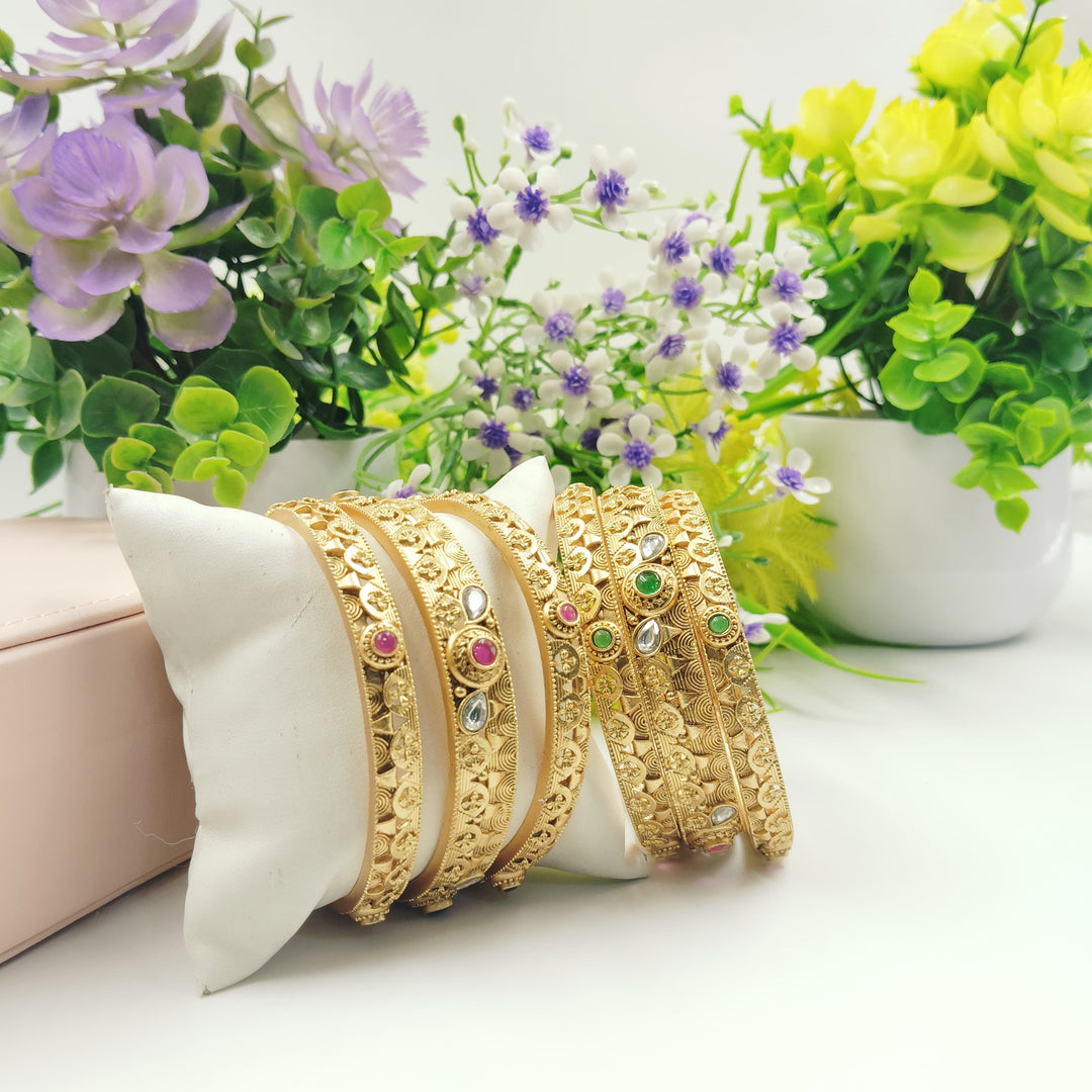 Golden bangles with a vintage look, perfect for retro style.