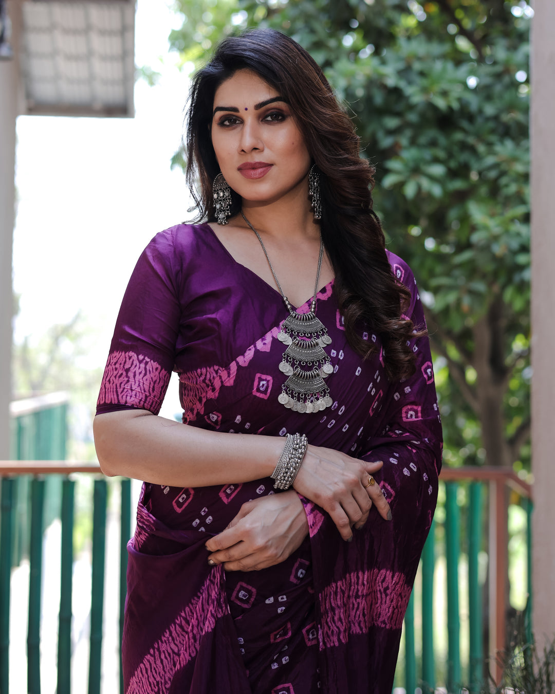 Purple Bandhej silk saree with intricate traditional motifs and a rich tissue pallu, perfect for special occasions.