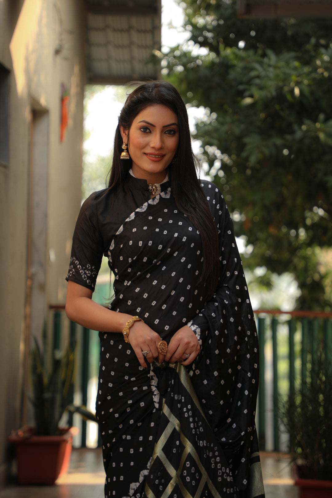 Elegant black Bandhej silk saree with stylish checks and luxurious Bandhej craftsmanship.