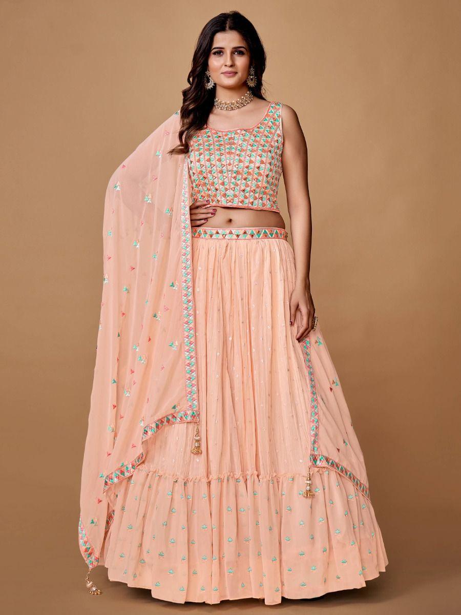 Peach lehenga choli with heavy embroidery and mirror work for events.