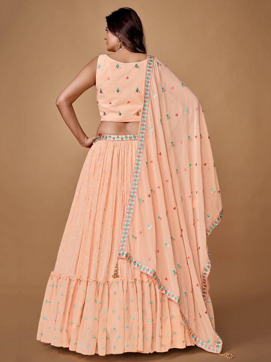 Peach embroidered lehenga with ruffle detailing for a trendy look.