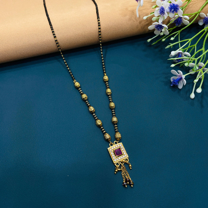 Sophisticated black and gold mangalsutra necklace, made with durable gold alloy, classic design.