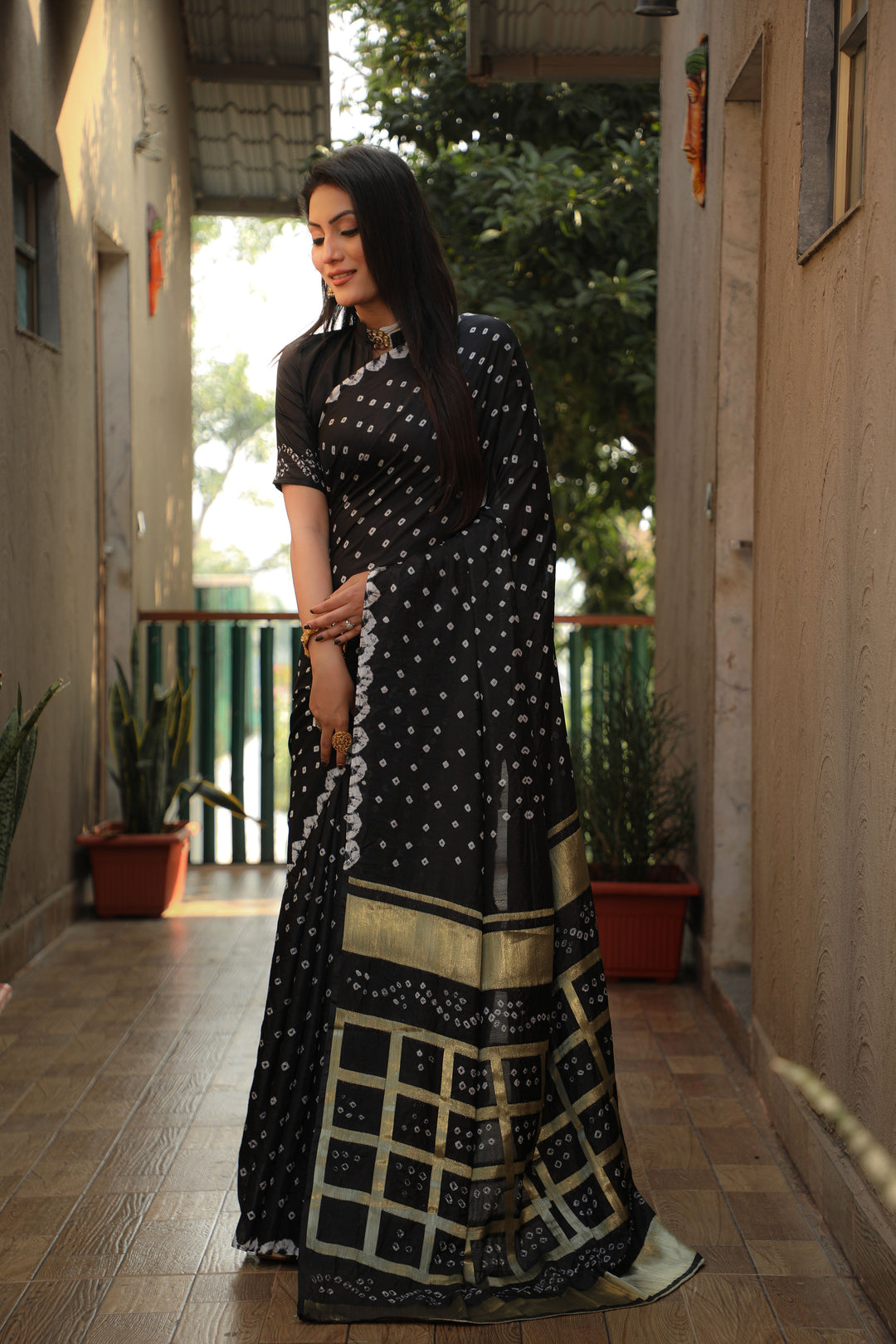 Timeless teal-green Bandhej silk saree with elegant checks design, perfect for special occasions.