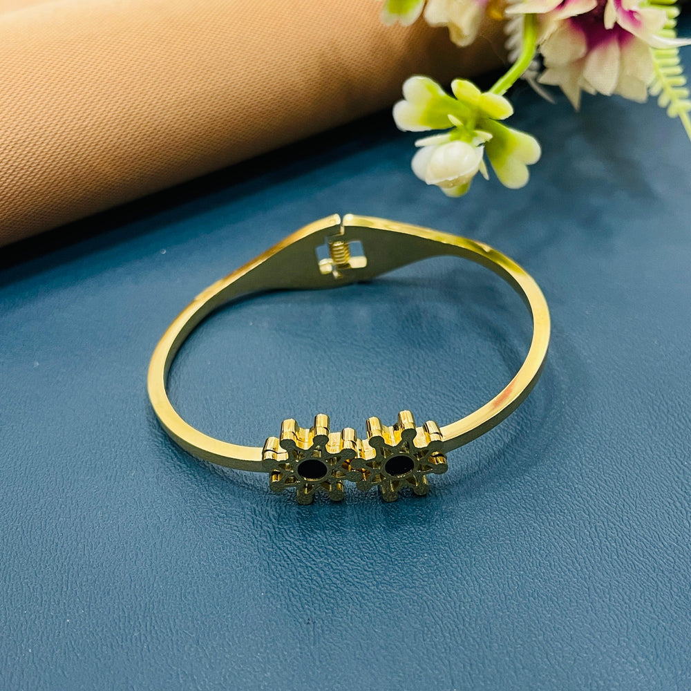 Sophisticated golden bracelet featuring gemstone detailing for added luxury.