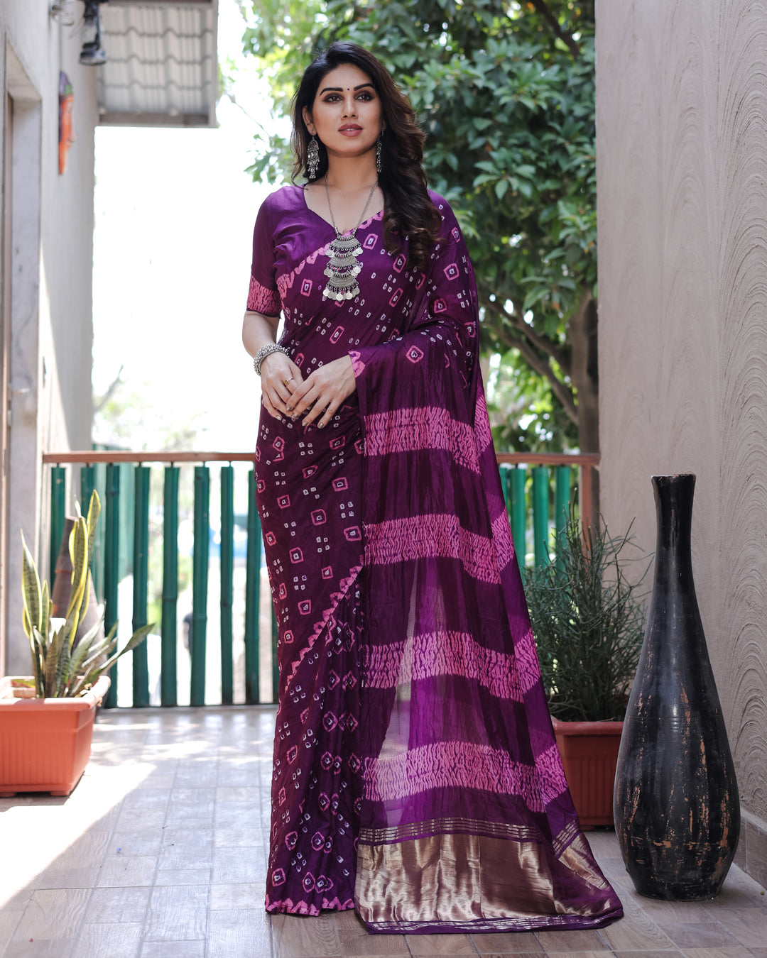 Beautiful purple Bandhej silk saree with exquisite designs and a luxurious tissue pallu, perfect for weddings and celebrations.