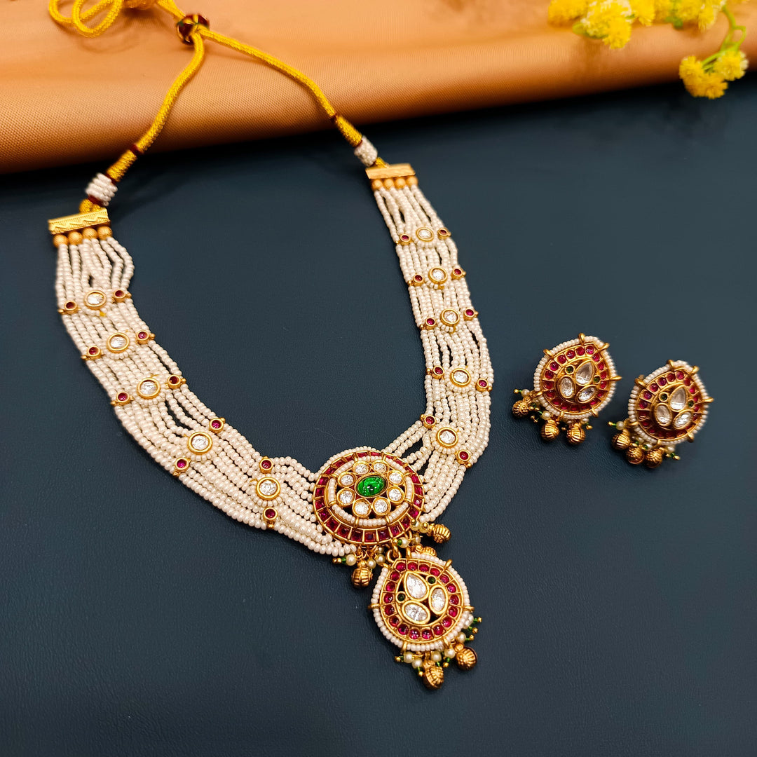 Classic Indian choker in gold metal with antique detailing, ideal for bridal wear and festivals.