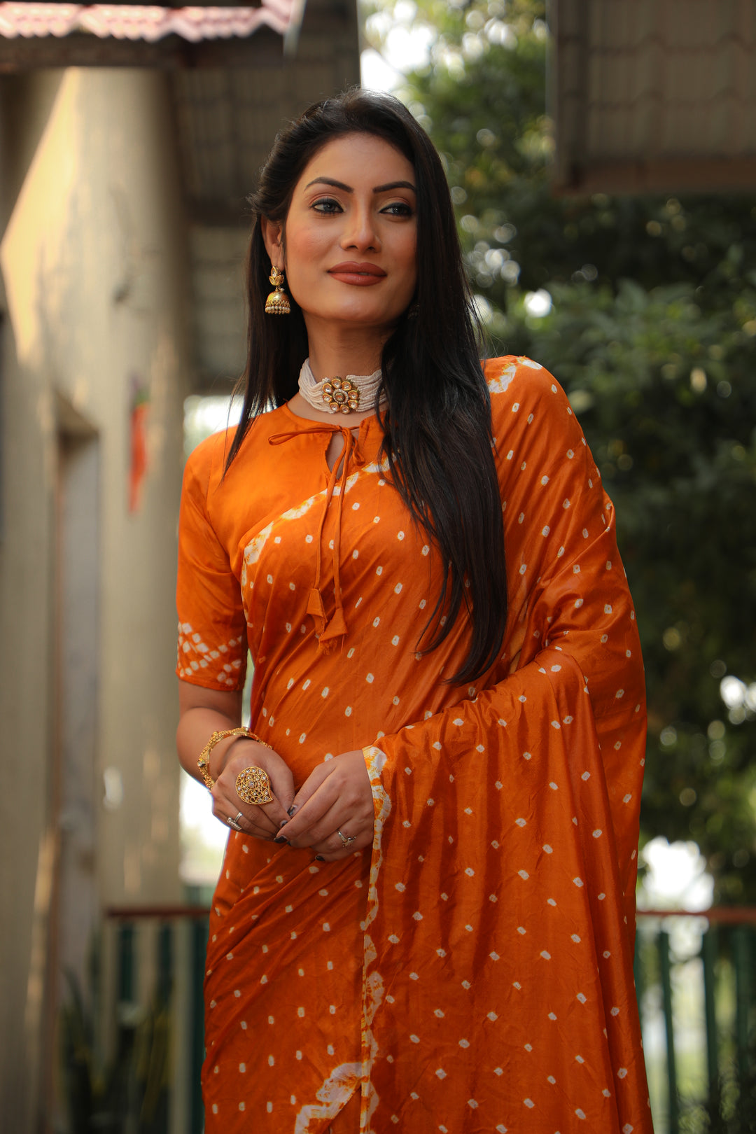 Stunning orange Bandhej silk saree with intricate checks pattern, perfect for festive occasions.