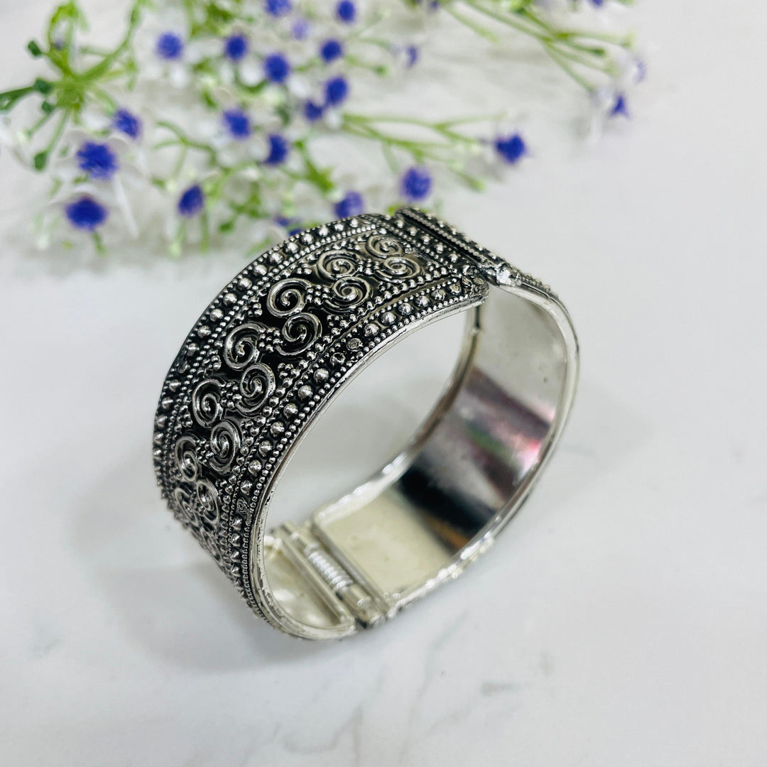 Timeless oxidised bangle adorned with colorful stones, adding flair to your outfit.