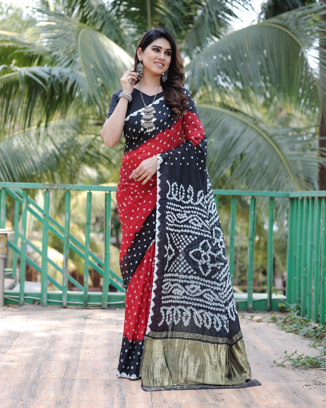 Black Premium Bandhej Silk Drapes with Zari Tissue Pallu and blouse piece for a sleek, luxurious style.