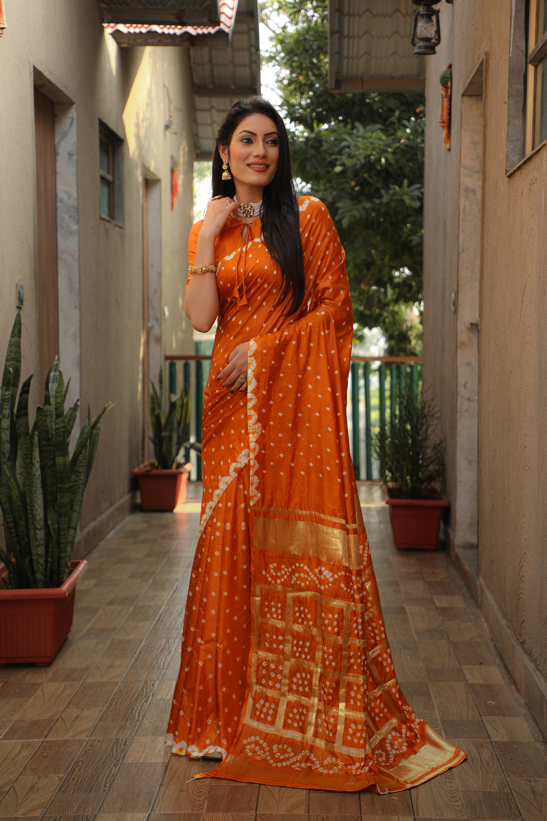 Elegant orange Bandhej silk saree with stylish checks design and luxurious feel.