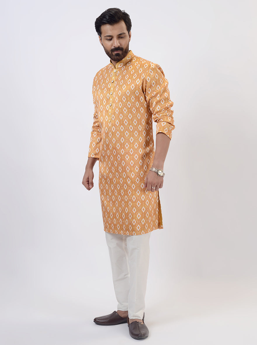 Stylish mustard yellow silk blend kurta pajama with unique Ikat print for festive events.