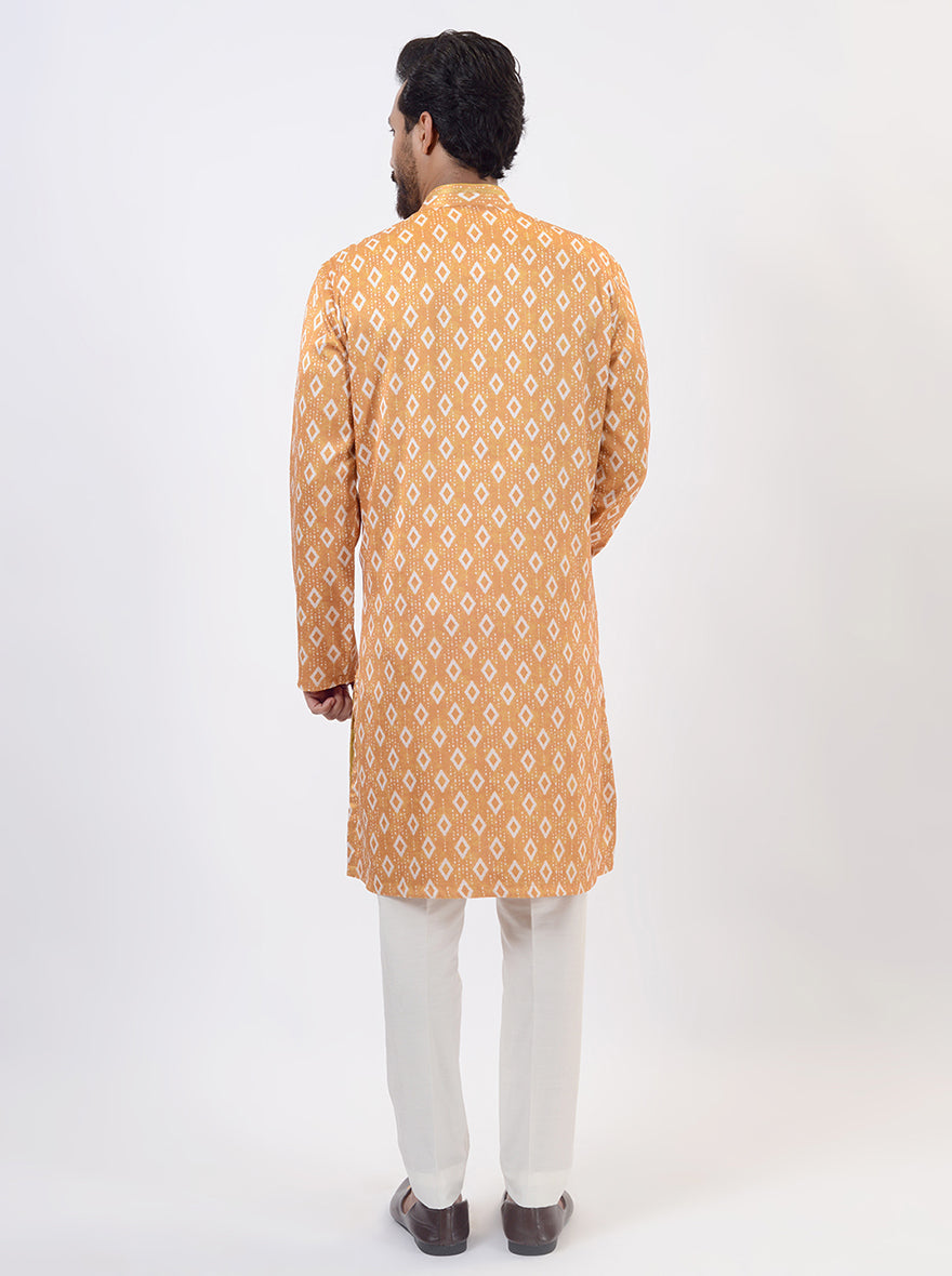 Men's kurta pajama in mustard yellow silk blend with traditional Ikat print, perfect for parties.