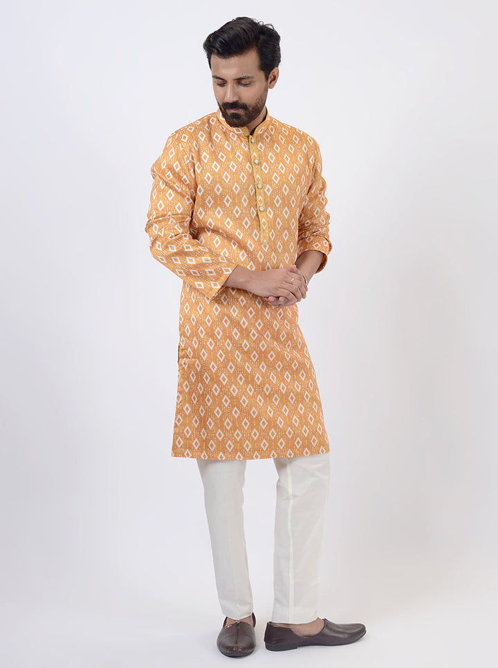 Mustard yellow silk blend kurta pajama with Ikat print, designed for special occasions in USA.