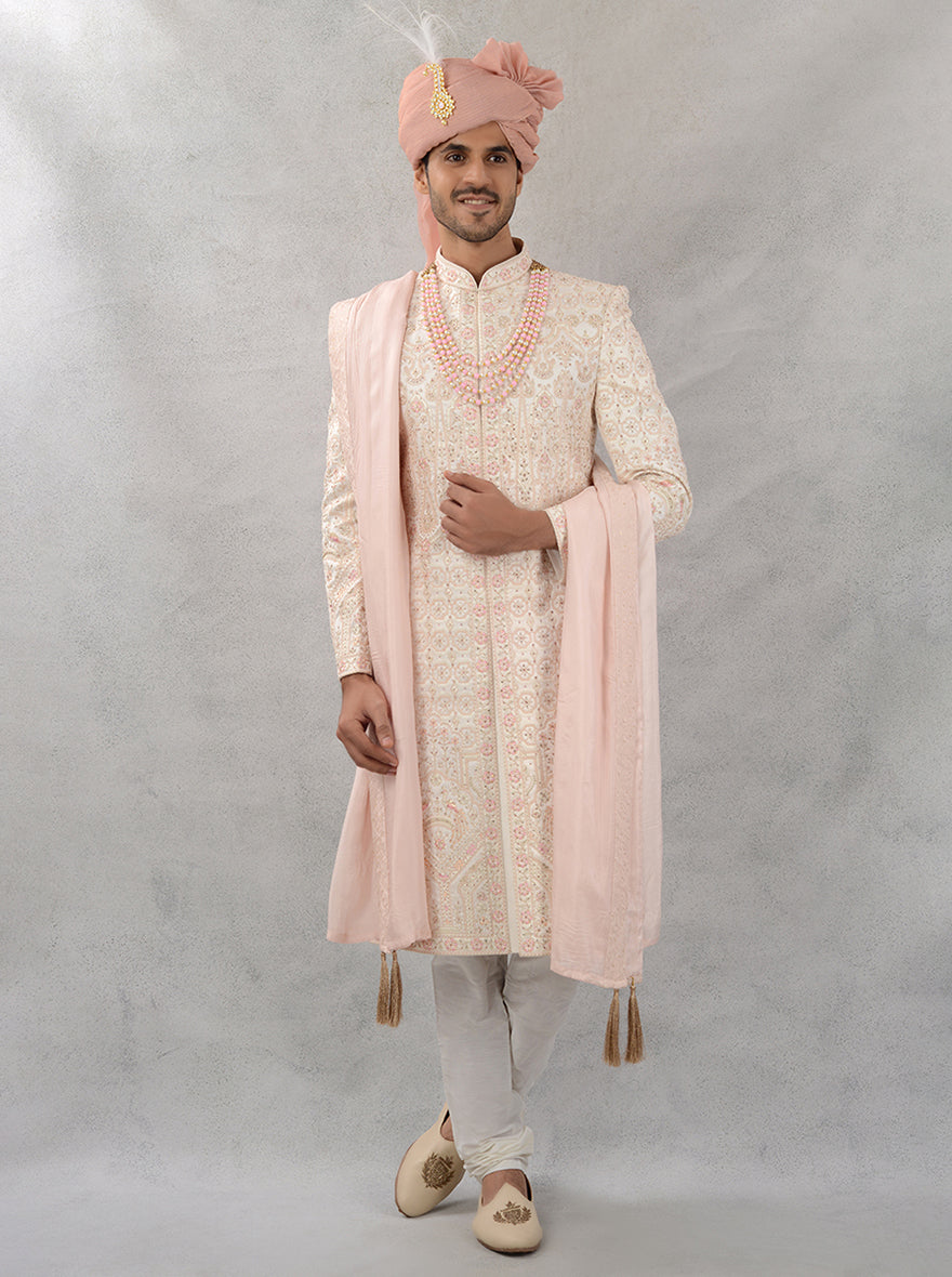 Perfect for grooms, this cream and peach embroidered sherwani offers a stylish and sophisticated look for wedding celebrations in the USA.