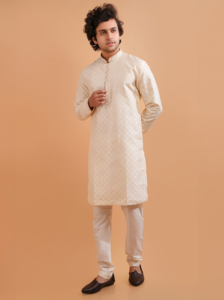 Men’s cream silk jacquard kurta pajama, featuring intricate design for cultural celebrations.