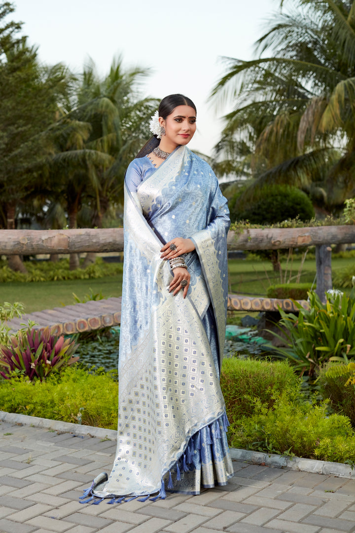 Beautiful blue Kanjivaram silk saree with delicate butta work and designer border, perfect for luxurious events.