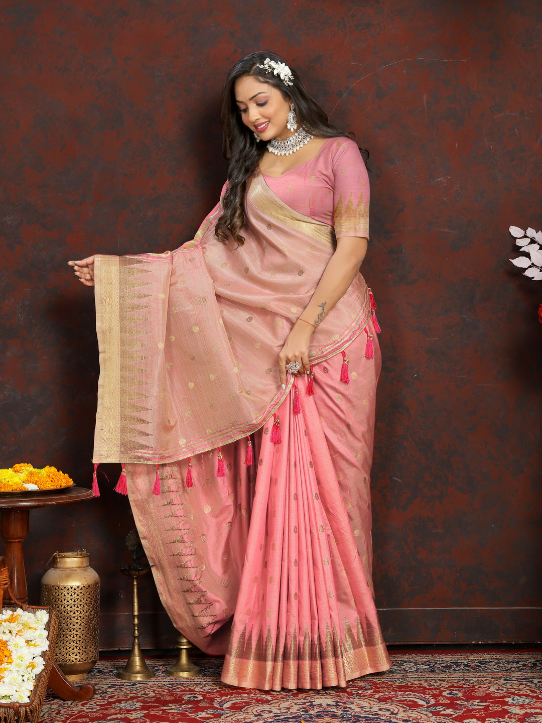 Soft Peach Silk Saree with intricate zari weaving and a stylish pallu tassel design for celebrations.