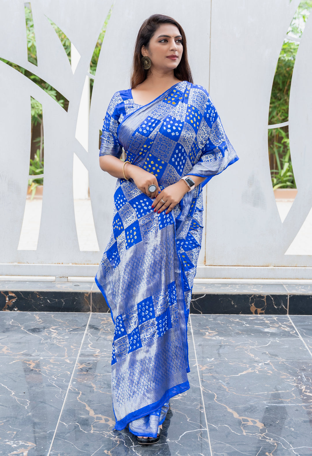 Beautiful blue Bandhej silk saree with an eye-catching drape and intricate zari border, perfect for weddings.