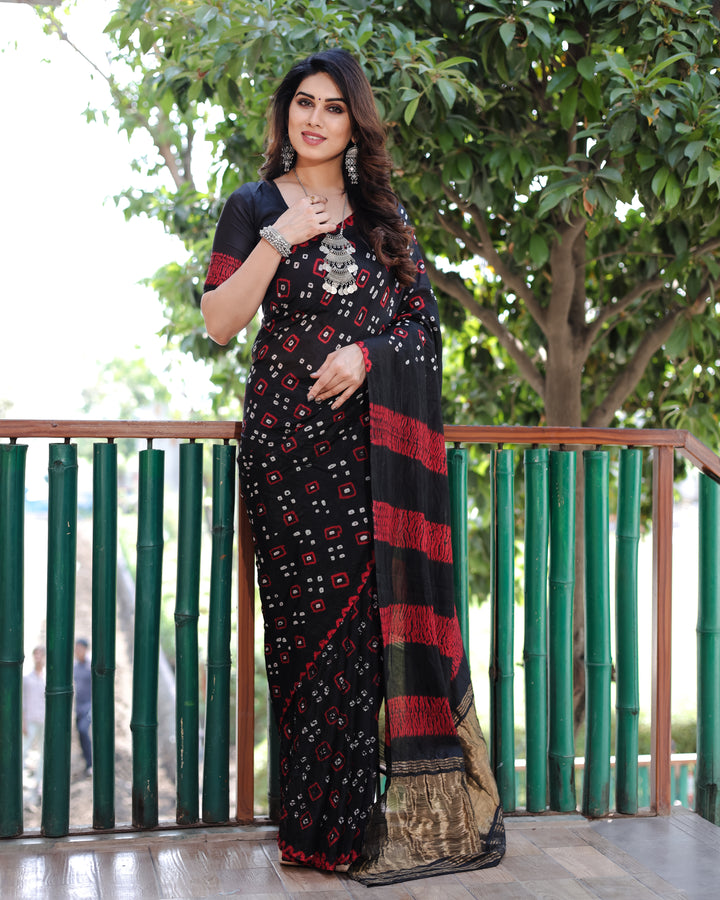 Elevate your festive wardrobe with this black Bandhej silk saree, designed with intricate patterns and stunning motifs.