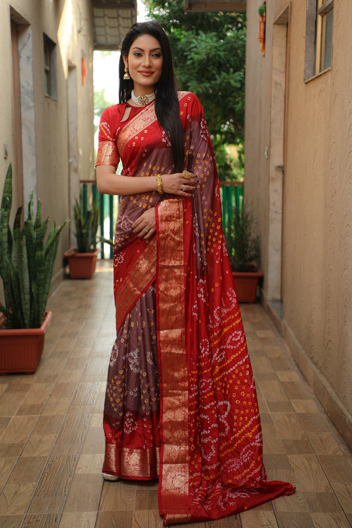 Elegant red Bandhej Tapeta saree with intricate weaving, perfect for festive events.