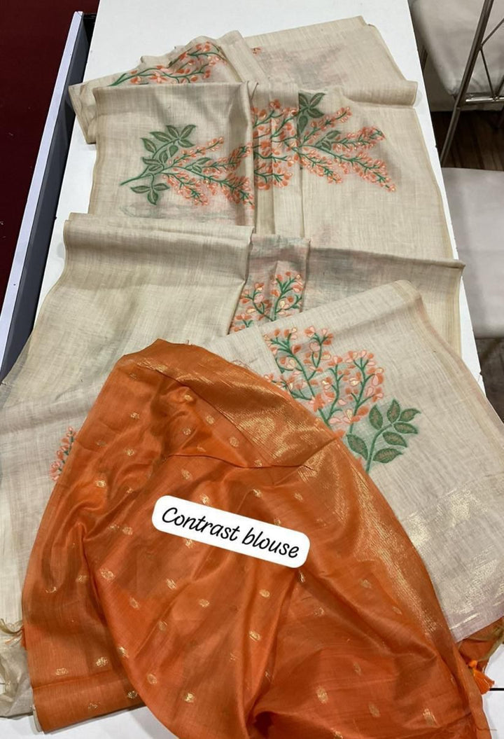 Muga cotton saree with floral weave, zari patta on pallu, and contrast blouse