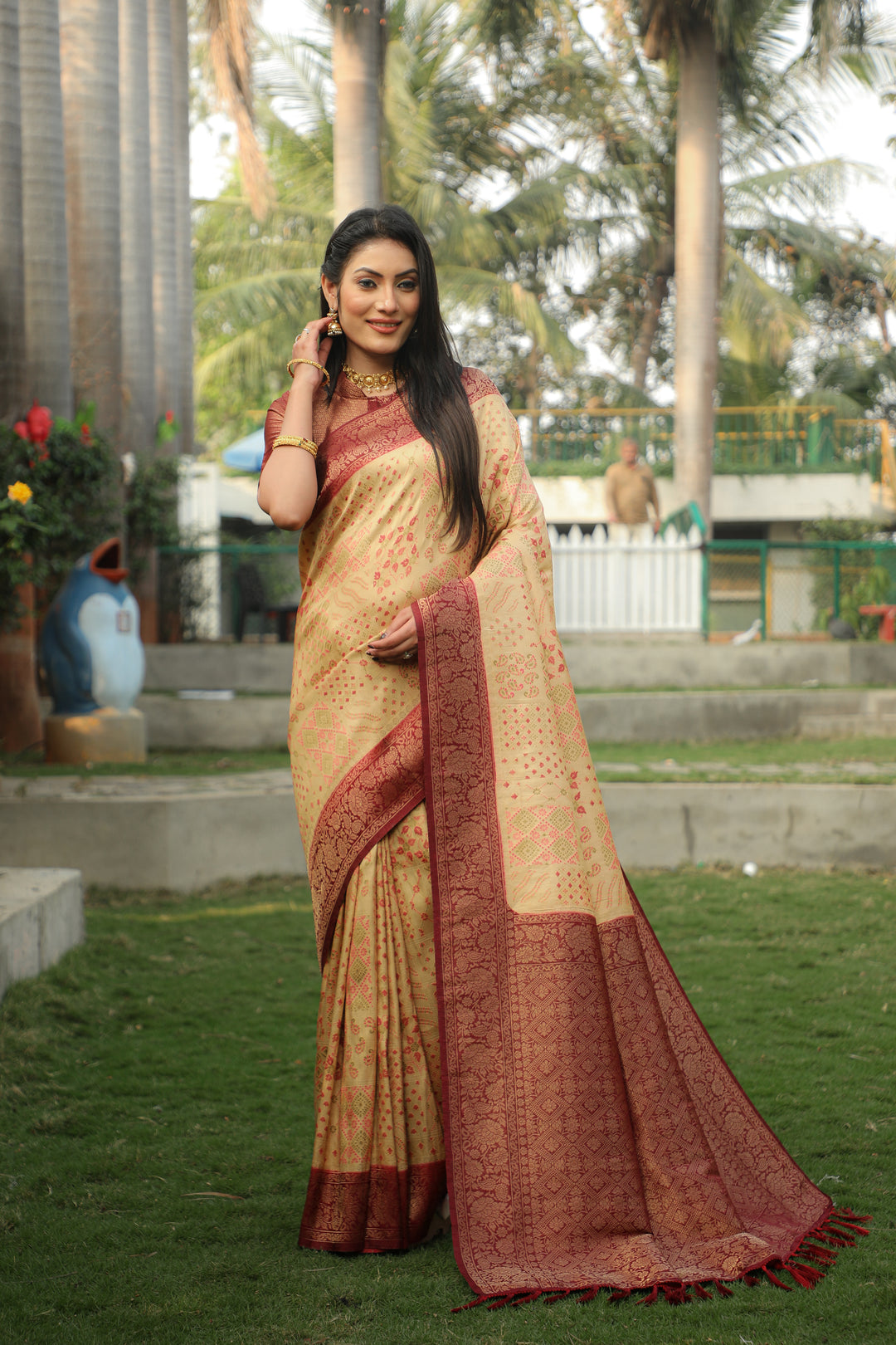 Vibrant cream Kanjivaram silk saree with intricate detailing, perfect for festive occasions.