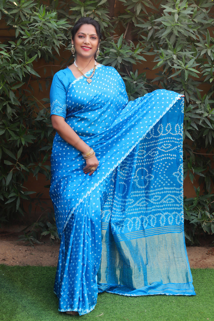 Sky blue Bandhej silk saree with Lagdi Patta and Zari woven pallu, an elegant choice for weddings and festive events.